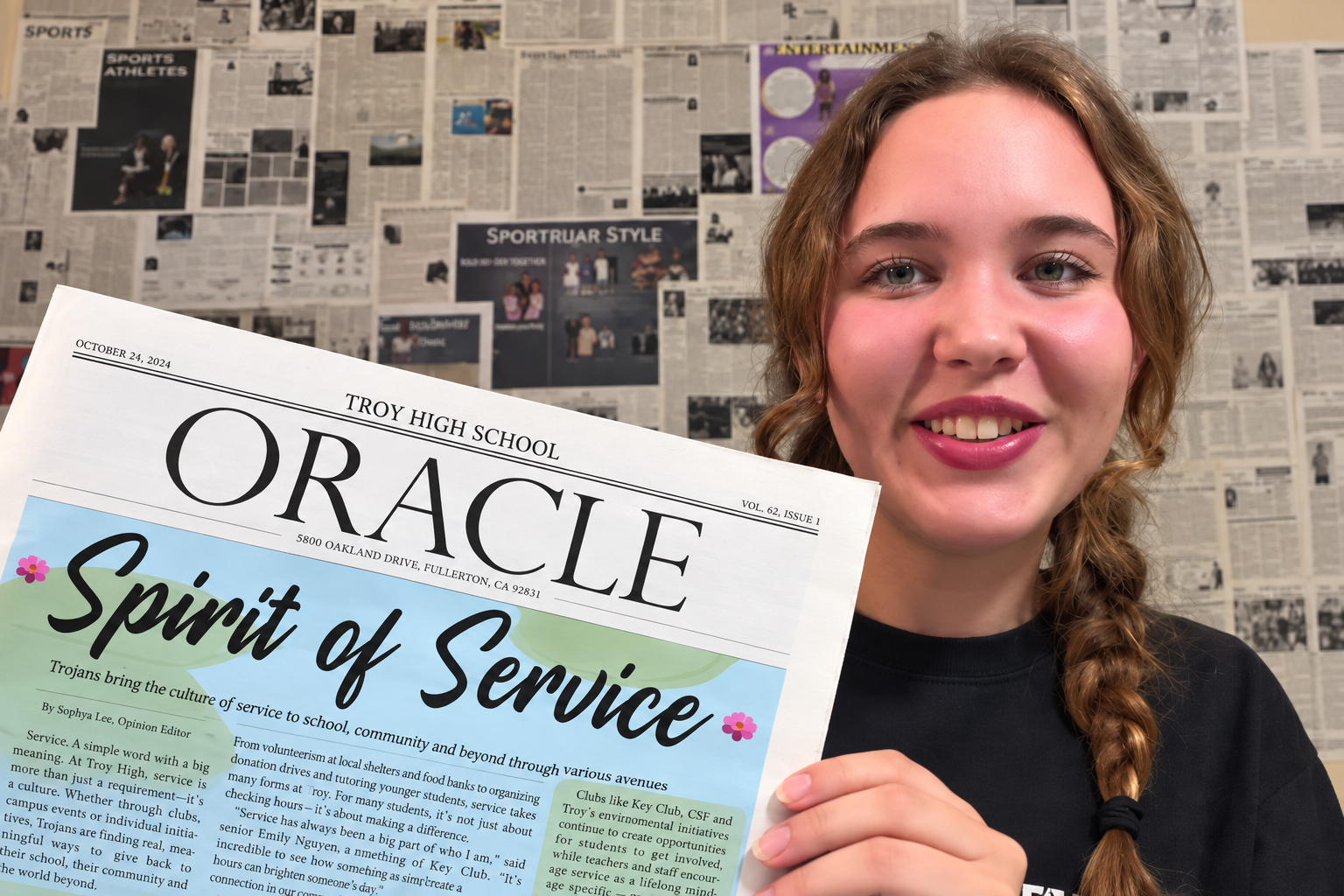 Anastasia Efremova holding The Oracle newspaper
